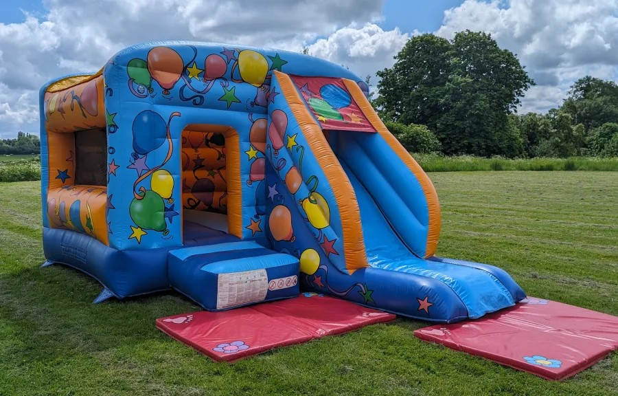 deluxe party bouncy castle with slide hire in Harlow garden setup