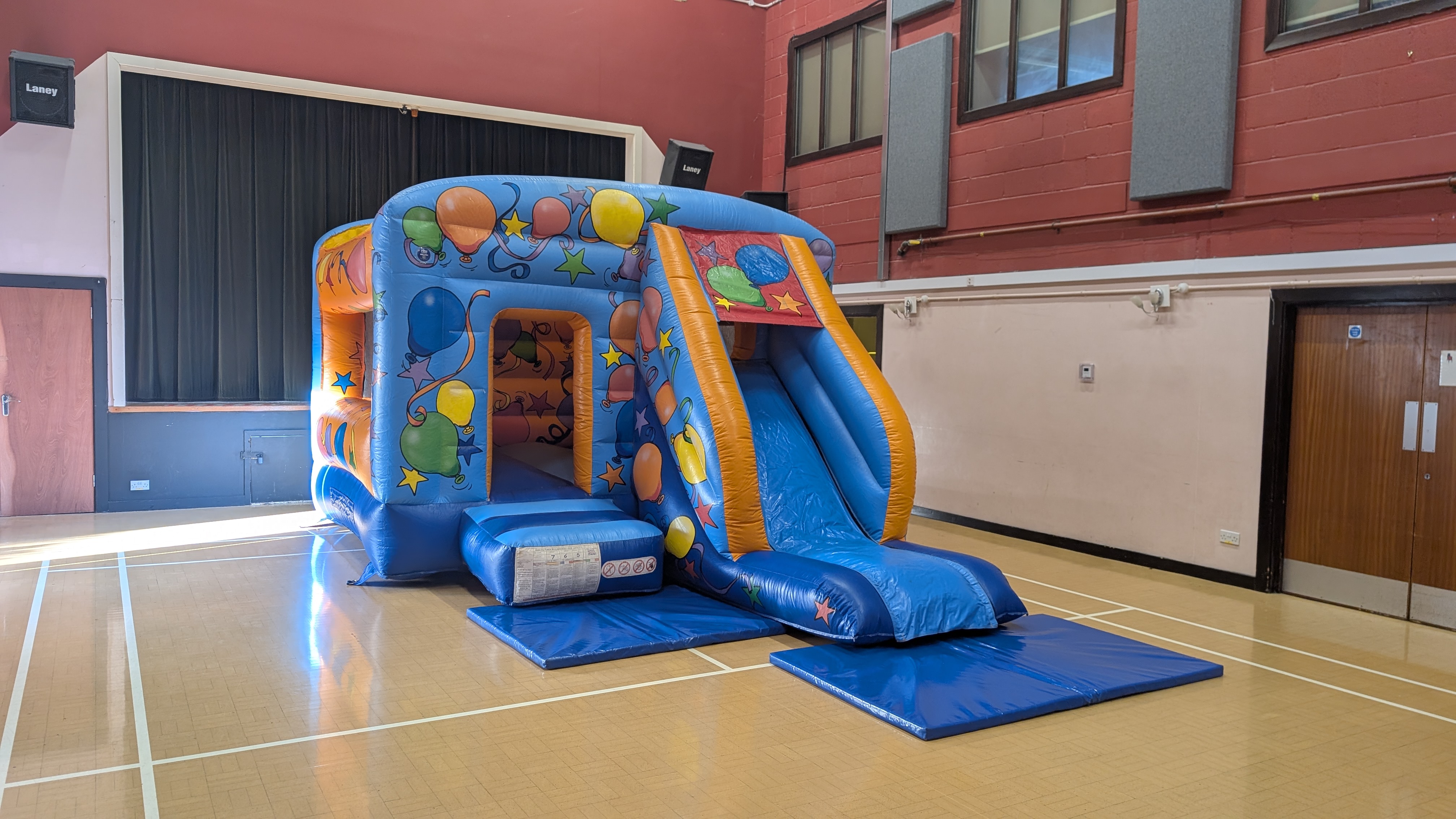 Bouncy Castle with Slide Hire in Buntingford bouncy castle with slide set up inside seth ward community centre in buntingford