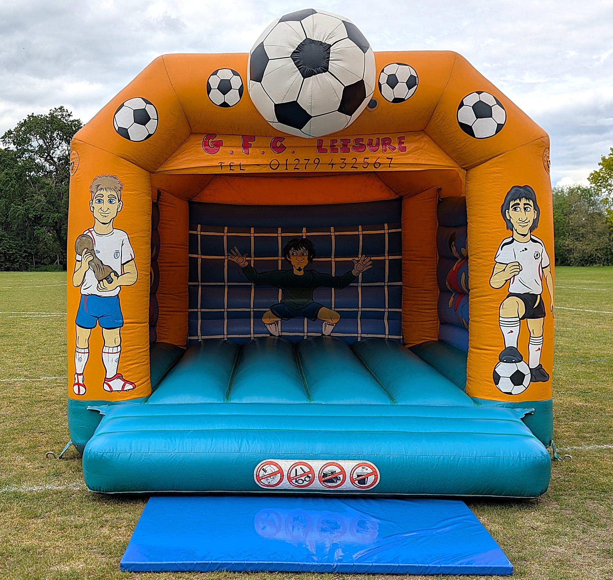 Football bouncy castle set up on a field in Enfield