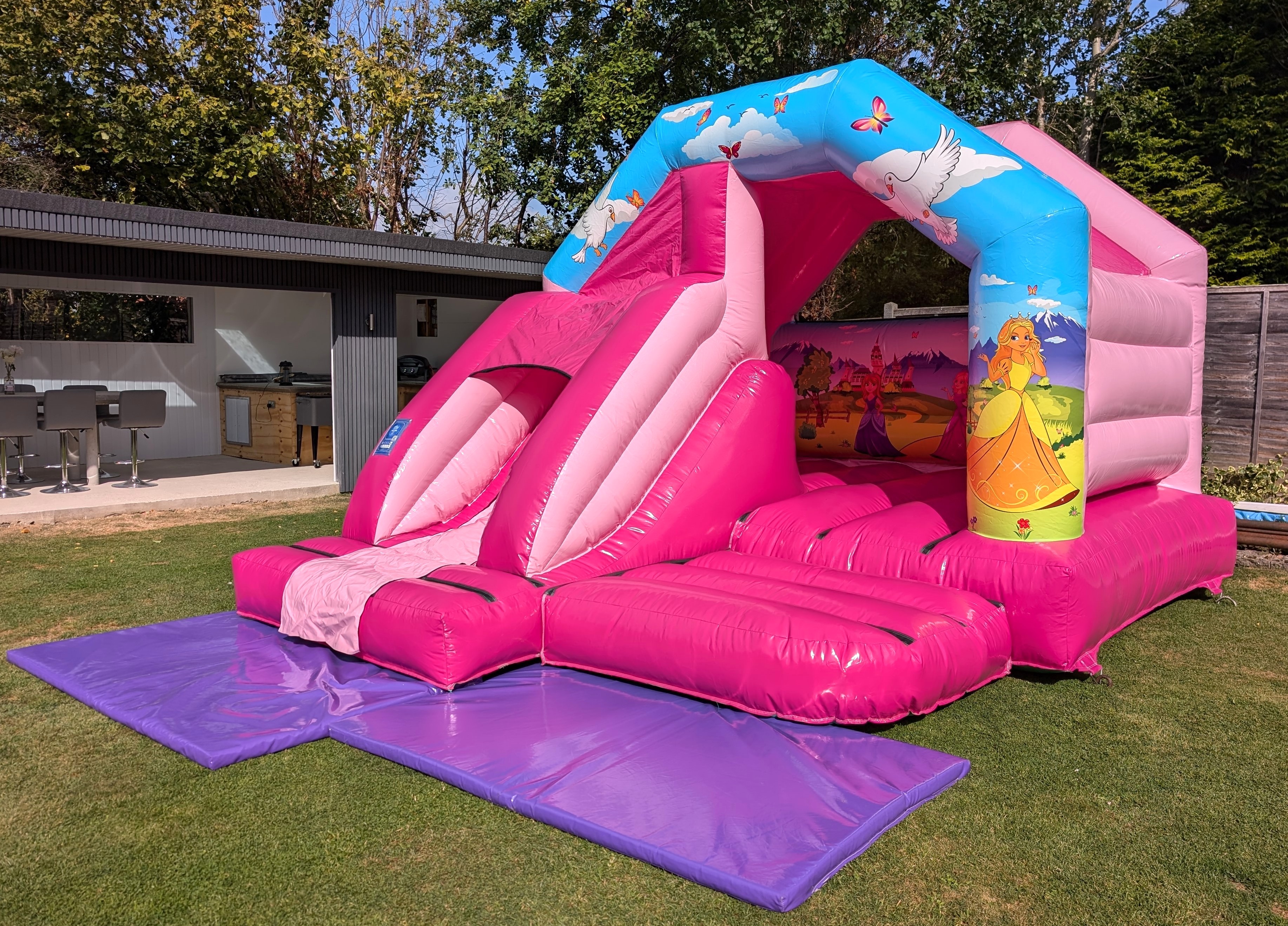 Princess Bouncy Castle with Slide in a garden in Dunmow