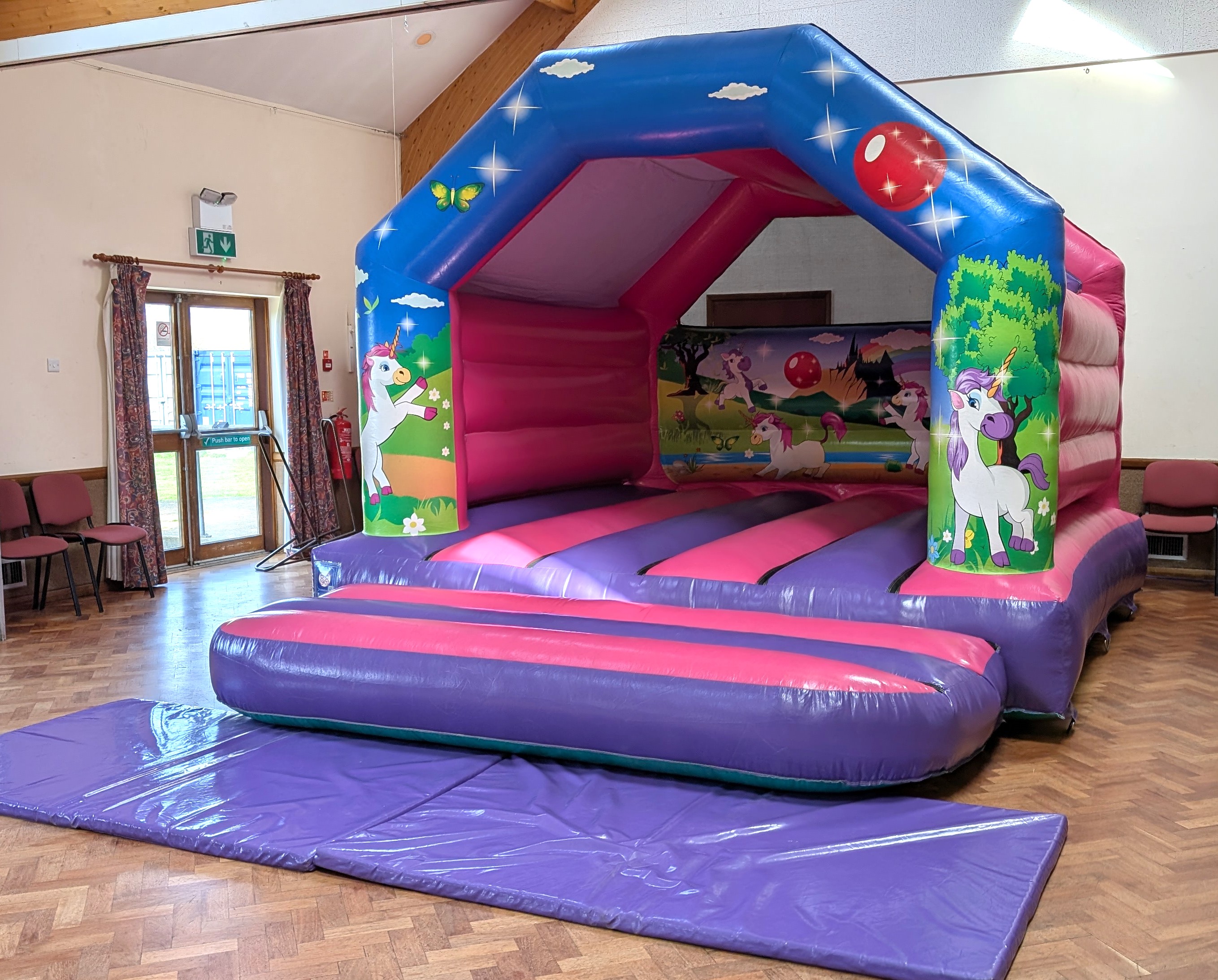 Unicorn bouncy castle set up in abridge village hall